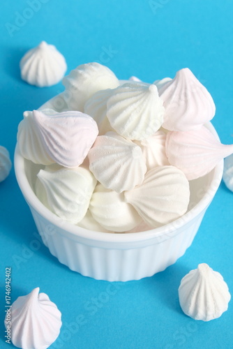 Obraz na plátně On a blue background there is a white Sasha with small marshmallows