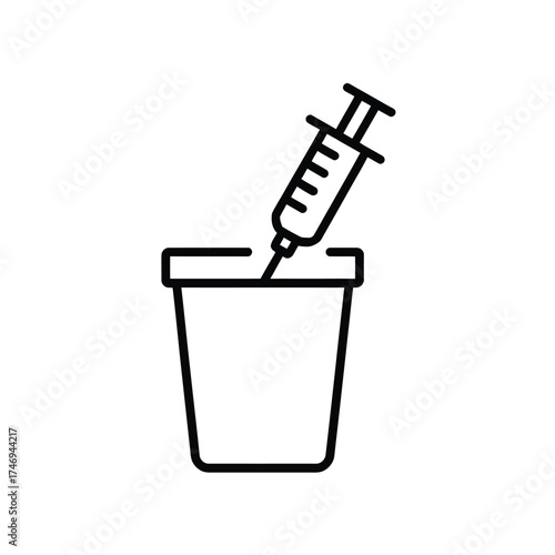 Medical syringe being disposed of in a sharps container