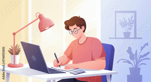 A diligent young man is engrossed in his studies or remote work, writing notes in a notebook at a well-lit desk with a laptop, showcasing a focused and productive home office or e-learning environment