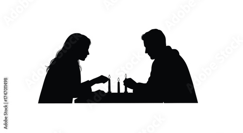 A silhouetted couple intently playing a game of chess facing each other
