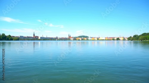 Wallpaper Mural The river reflects the riverbanks as the skyline stretches along the river. Buildings line the river, and trees border the opposite riverbanks under a clear sky. Torontodigital.ca