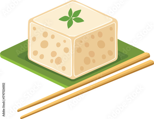 A block of tofu garnished with fresh green leaves, served on a green plate with chopsticks.