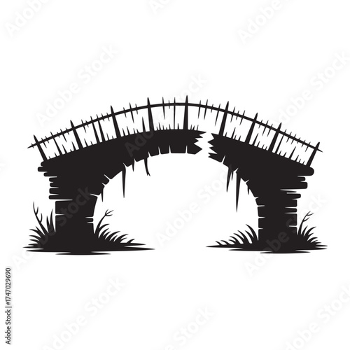 Silhouette of an old weathered stone arch bridge with broken wooden railing and overgrown grass