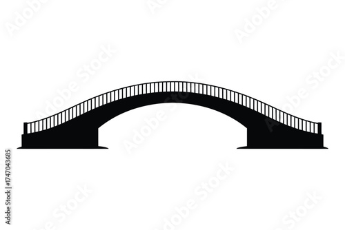 Silhouette of a black arch bridge with railings