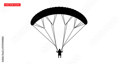 Silhouette of a Parachutist with Open Parachute in Flight.
