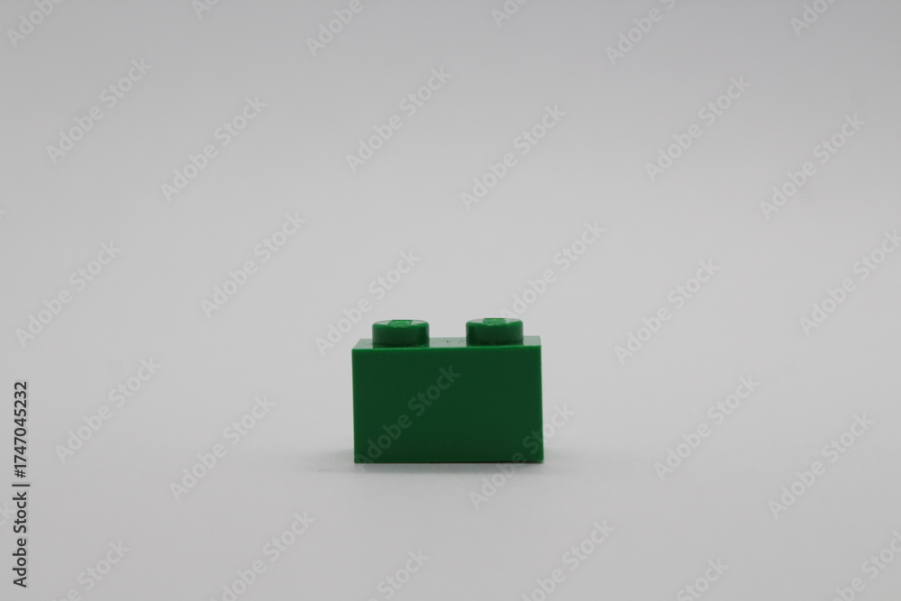 Naklejka premium Green Lego brick piece isolated on a white background