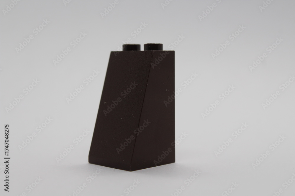 Obraz premium Black Lego brick piece isolated on a white background 