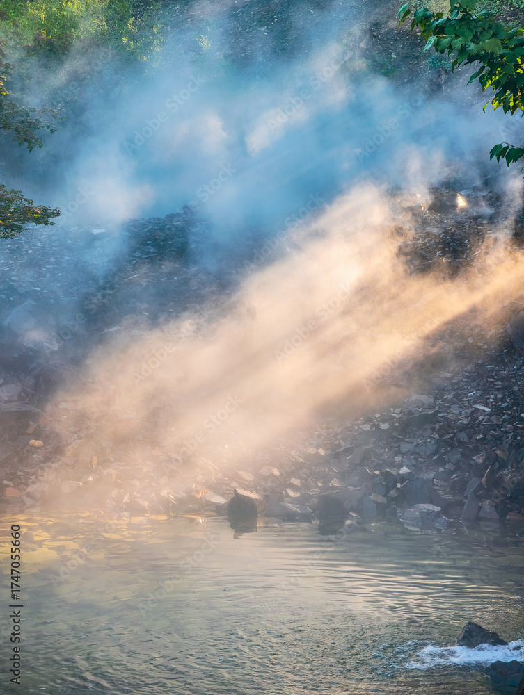 Obraz premium Natural Hot Spring Steam Rising Over Water - Geothermal Landscape with Mist and Rocks for Wellness and Nature Travel Content. Ultra High Resolution 