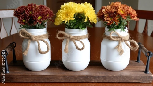 Wallpaper Mural Three jars holding vibrant yellow and maroon flowers sit on a wooden tray, adding charm and color to any space or event Torontodigital.ca
