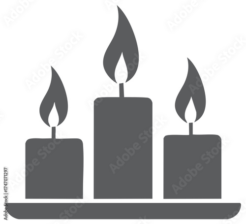 Three burning candles on a tray illuminated by soft light for a warm and serene atmosphere