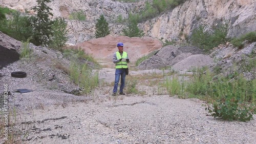 Construction worker inspecting material amount using tablet on construction site