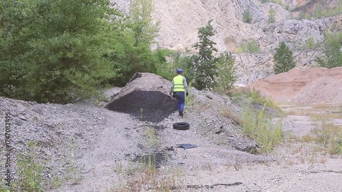 Construction worker inspecting material amount using tablet on construction site