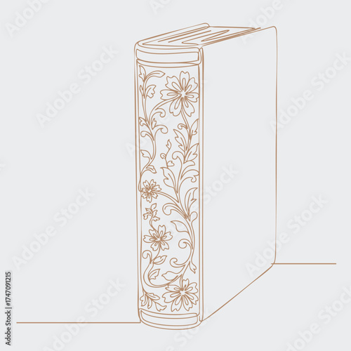 Elegant hardcover book with intricate floral patterns on the spine, standing upright on a flat with a plain