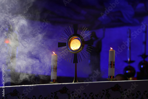 Sacred objects on the altar in a church at night with candles