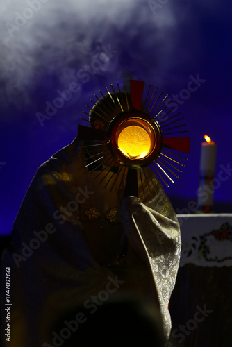 Priest holding the Blessed Sacrament of the Eucharist,