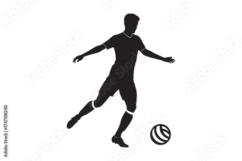 Silhouette of a soccer player kicking a ball