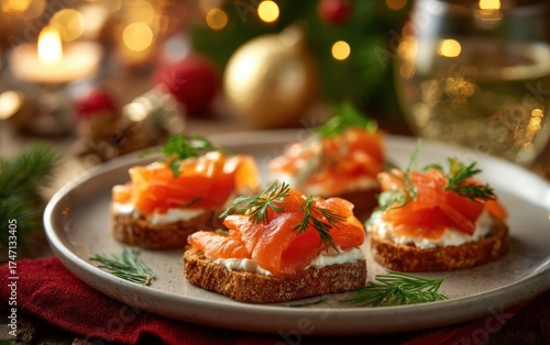 A plate of four small sandwiches with salmon and dill