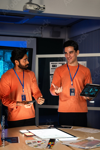 Software developer or creative designer presents UX, UI development design to team. Man explains data on a tablet. Digital consultation, tech solutions. Critical security project for new product