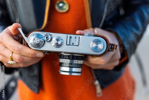 girl travels and photographs landmarks. Stylish girl with film camera.