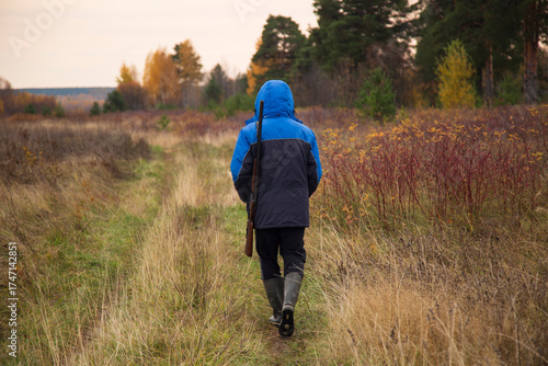 Duck hunting . A man with a gun on a duck hunt.