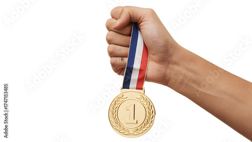 Hand holding first place gold medal with ribbon isolated on white background to celebrate victory