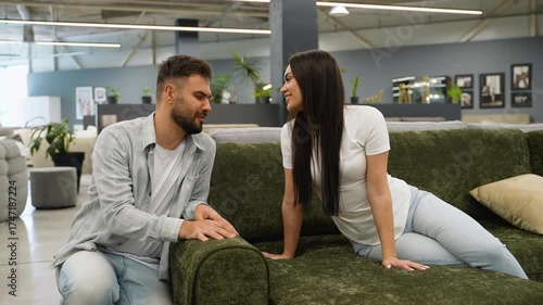 Newlyweds couple choosing new sofa furniture together