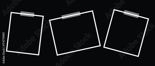 Three blank photo frames taped to a, ideal for creating a minimalist display or showcasing images with contrast