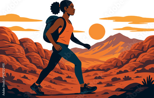 An athletic African American woman hikes through Nevada's red rock canyon at sunset