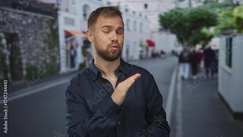 Wallpaper Mural Man pointing finger on city street while making a dismissive hand gesture, beard visible and wearing navy shirt; playful confidence. Torontodigital.ca