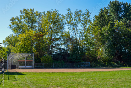 Baseball field with backstop and trees in the background