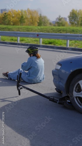 A Caucasian woman on a scooter after being hit by a car.