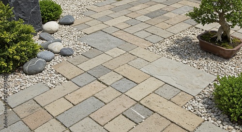 Serene garden pathway featuring interlocked paving stones and decorative pebble ground covering