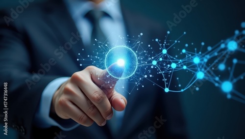 A professional in a suit is seen interacting with a glowing digital network interface, using his finger to trigger a connection or activation within a virtual system, concept of technology and...