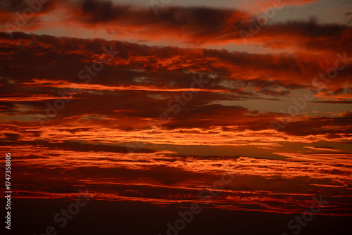 dramatic red sunset sky with luminous clouds