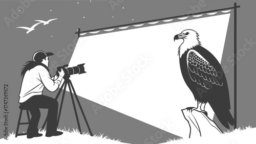 Photographer taking a picture of a bird of prey on a white backdrop.