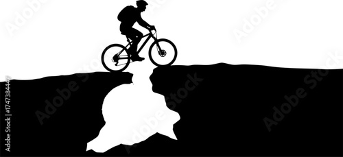 Mountain biker silhouette at sunrise with glowing sky and ridge outline for travel and adventure design use