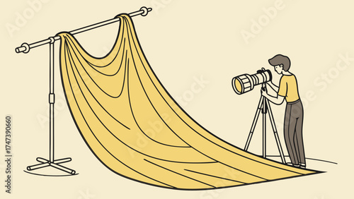 Photographer using a large camera lens with a yellow backdrop.