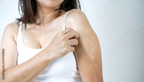 Woman examining skin discoloration on her arm