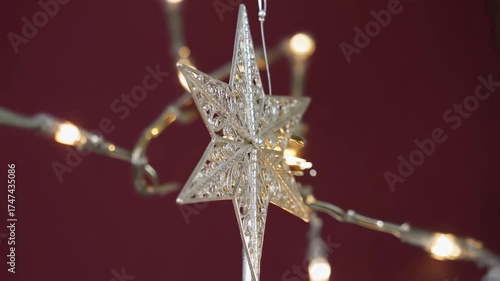 Wallpaper Mural Intricate silver Christmas star tree topper rotating slowly against a festive red background with warm bokeh lights. Torontodigital.ca