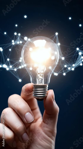 Hand holding a glowing light bulb with abstract connections, symbolizing innovation and bright ideas.