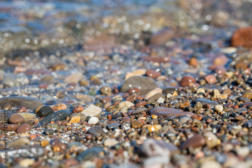 Lake Ontario shoreline with colorful stones and crystal clear freshwater.  
