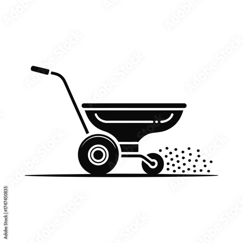 Black silhouette of a spreader spreading granules on a lawn