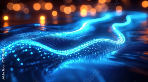 Glowing blue wave of digital particles flowing smoothly against a dark background with warm orange bokeh lights creating a futuristic and dynamic atmosphere
