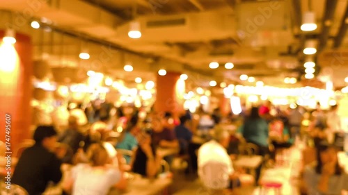 Blurred people' activities in food court.	