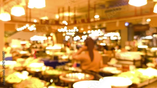 Blurred people' activities in food court.	