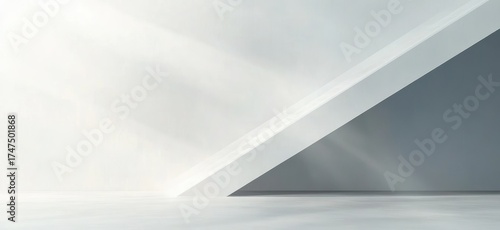 Fototapeta Naklejka Na Ścianę i Meble -  Minimalist empty interior space with white and gray angled walls and sunlight casting soft shadows on the floor