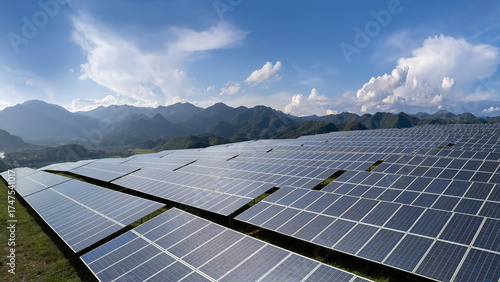 Solar panels in a scenic mountainous area under a clear sky