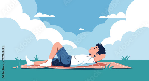 Man relaxing and enjoying the day lying on a blanket under a bright blue sky