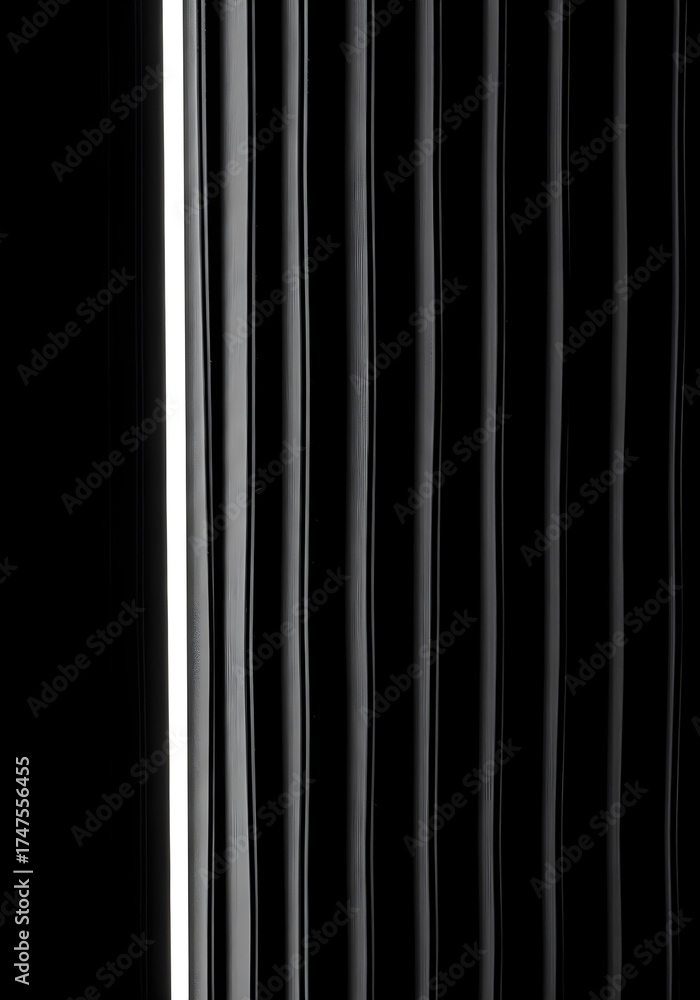 Obraz premium Monochrome abstract background of vertical glossy black stripes with dramatic highlights and shadows.