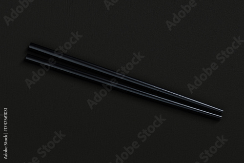 Pair of reusable chopsticks on dark background